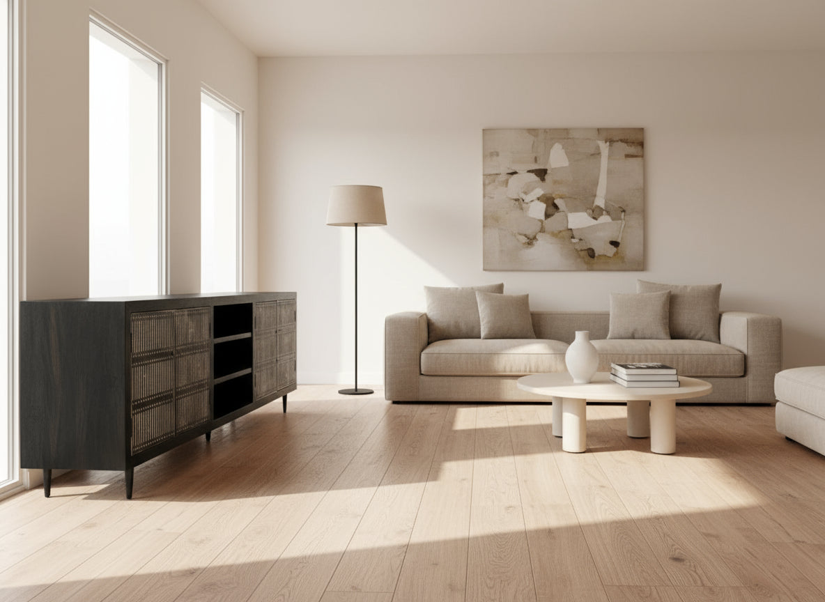 Black entertainment console with metal mesh doors on a wooden floor.