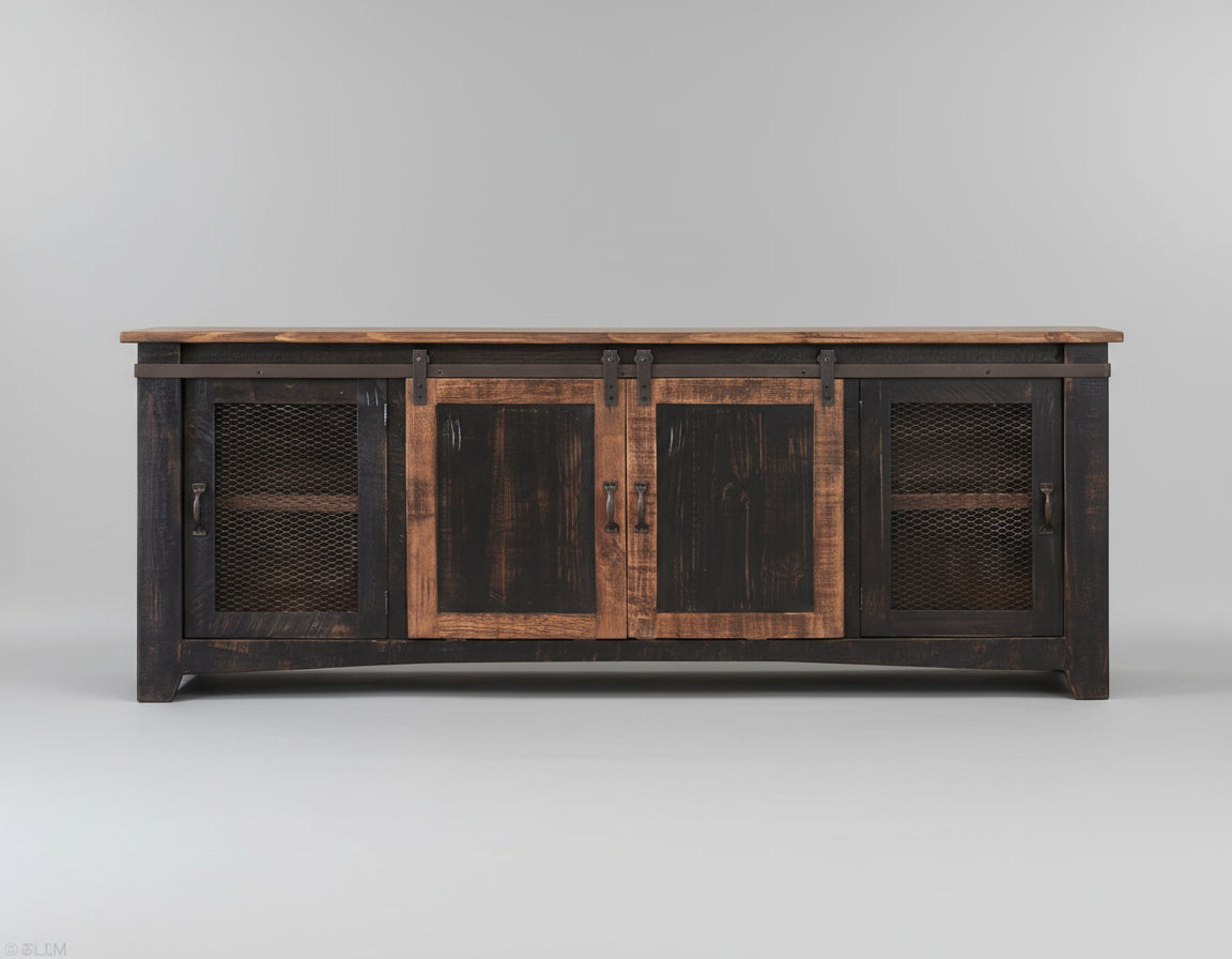 Wooden entertainment console with black distressed finish against a pink wall.