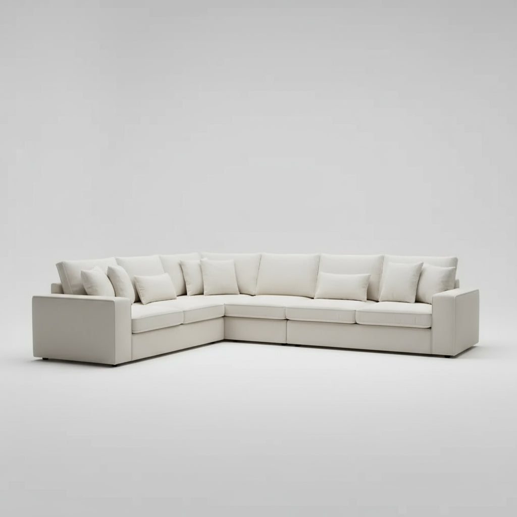 Close-up of a light gray sectional sofa with cushions on a white background