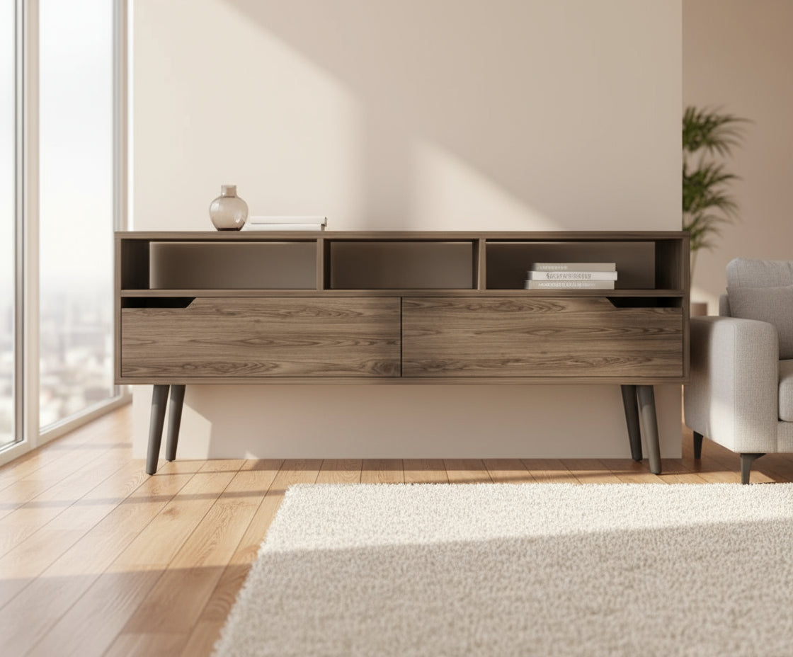 Wooden console table against a green wall on a wooden floor